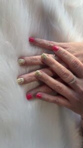 Hands with colorful and polka dot nails.