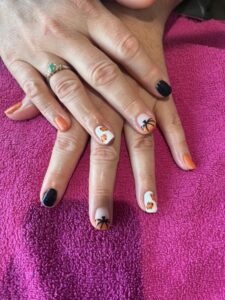 Halloween-themed nails with spider nail art.