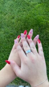 Red nails with leopard print design.