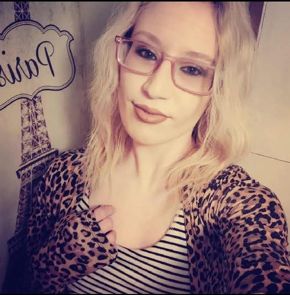 Blonde woman wearing glasses taking a selfie